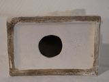 a small white box with a black hole in it