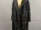 the coat is black and white and has a fur collar