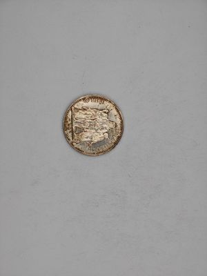 a close up of a coin on a white surface
