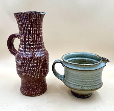 two vases sitting next to each other on a table