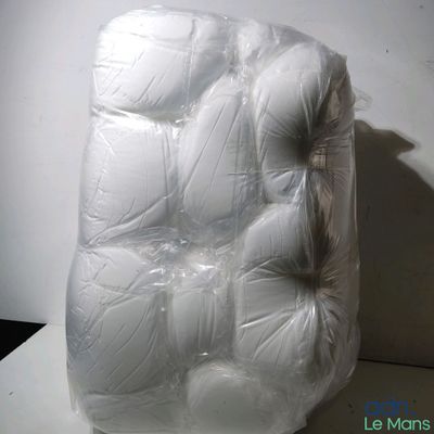 a large pile of white balls wrapped in plastic