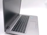 a laptop computer that is sitting on a white surface