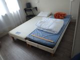 a bed that has a mattress and a pillow on it