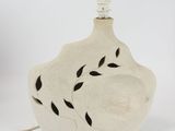a white vase with a black leaf design on it