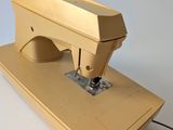 a yellow sewing machine sitting on top of a white table