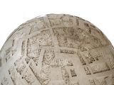 a white ball with a pattern on it on a white surface