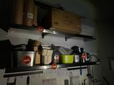 many pots and pans on the shelves in the kitchen