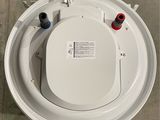a toilet that is sitting on the floor with the lid up