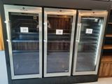 three glass doors that are open in a store