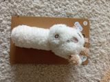 a stuffed animal that is laying on top of a box