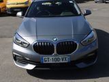 a silver bmw car parked in a parking lot