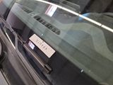 a car that has a sticker on it ' s windshield