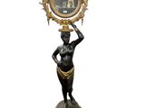 statue of a woman holding a mirror on her head