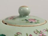 a close up of a teapot with flowers on it