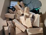 a cardboard box full of wood pieces and other items