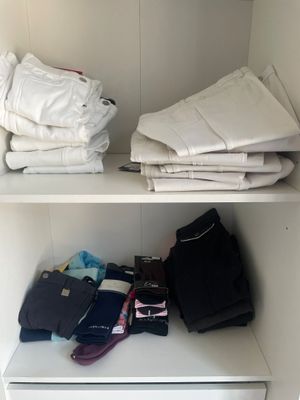 a closet with a lot of folded clothes on the shelves