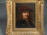 a painting of a man with a red hat in a gold frame