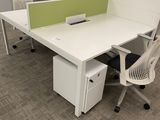 a desk with a chair and a computer on it