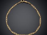 a gold chain bracelet with links and a clasp on a black background