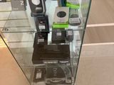 a glass display case with various electronic devices in it
