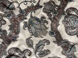 an image of a close up of a bed with a floral pattern on it