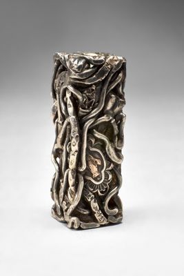 a close up of a silver vase with a snake on it