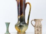 three vases sitting next to each other on a white surface