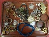 a wooden tray with a tray of jewelry on it