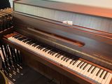 a piano that is sitting in the corner of a room