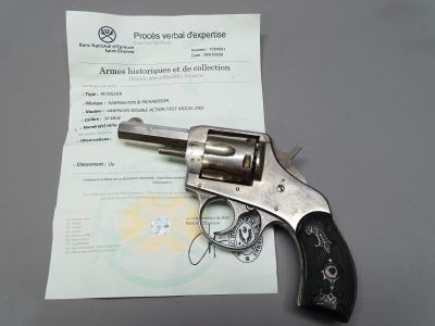 a revolver that is sitting on top of a piece of paper