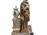 a statue of a man that is standing next to a vase