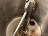 a metal bowl with a metal handle in it