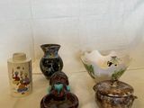 trois vases différents posés sur une table, sur fond blanc