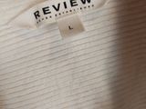 a close up of a white shirt with a label on it