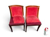 pair of red velveted chairs with wooden legs