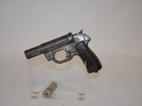 a gun that is sitting on top of a glass stand