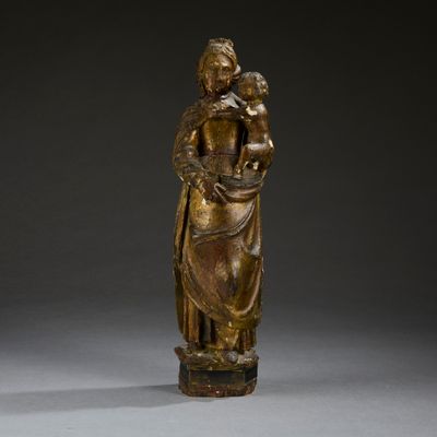 a gold statue of a woman holding a child in her arms