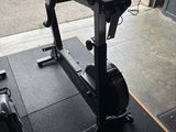 a bike that is sitting on the floor next to a suitcase