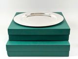 two green boxes with a white plate on top of them