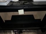 a black stove with a microwave on top of it