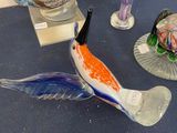three glass fish figurines sitting on a table