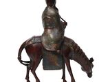 bronze statue of a man riding a horse with a hat on
