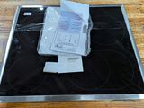 a stove top with a lot of papers on top of it