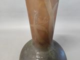 a vase that has a brown and white design on it