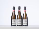 three bottles of wine sitting on top of a table next to each other