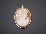 a gold and shell cameo of a woman in profile