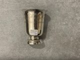 a silver cup that is sitting on a table