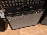 two amps sitting next to each other on a wooden floor