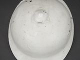 a white helmet with a hole in the middle of it