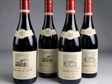 three bottles of red wine are lined up on a table